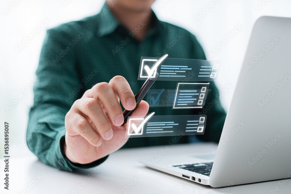 Man using laptop checking tasks on digital checklist interface Man using laptop checking tasks on digital checklist interface