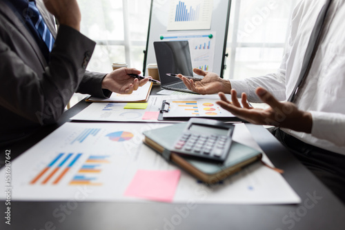 Obraz na plátně Financial advisor analyzing financial report and chart at meeting