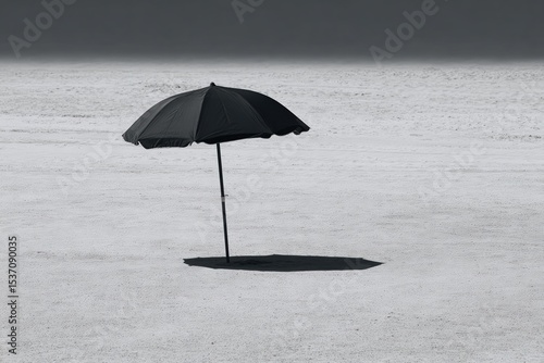 Wallpaper Mural Black beach umbrella casting a long shadow on the sandy shore in a bright setting Torontodigital.ca