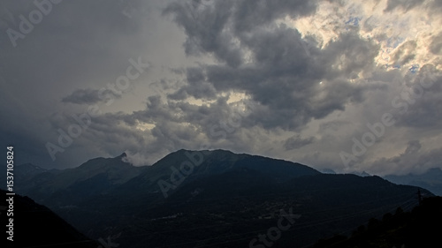 ark stormy clouds over silhouette of mountains in Vanoise national park, France 