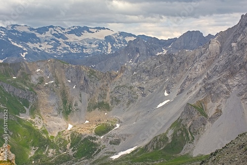 Mountains with glaciers under a cloudy sky in La Vanoise national park, Savoie, France 