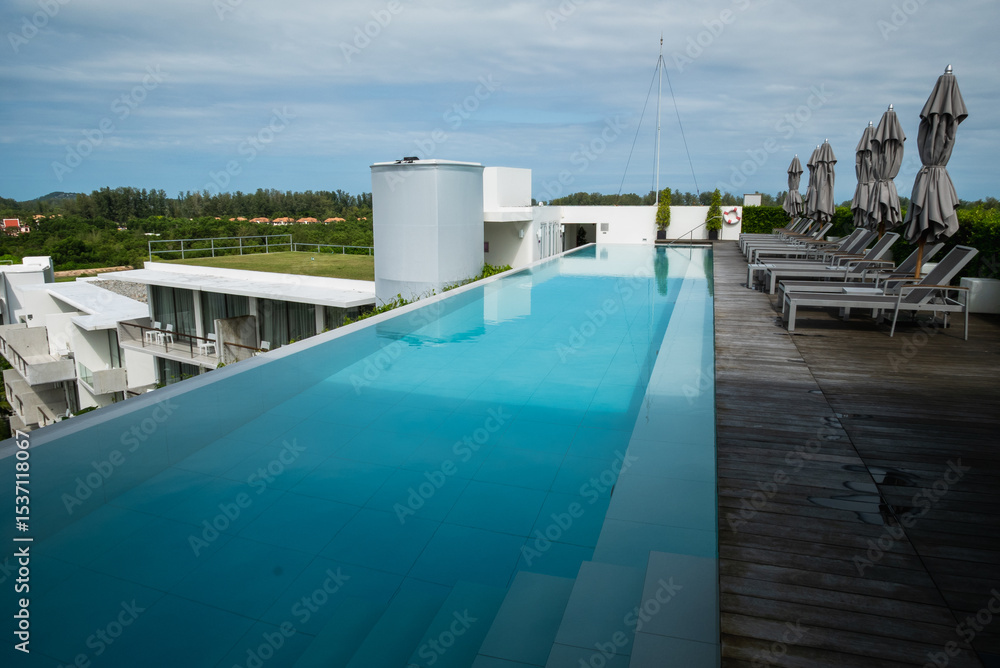 Fototapeta premium Relaxing infinity pool overlooking scenic landscape luxury resort modern architecture tranquil environment
