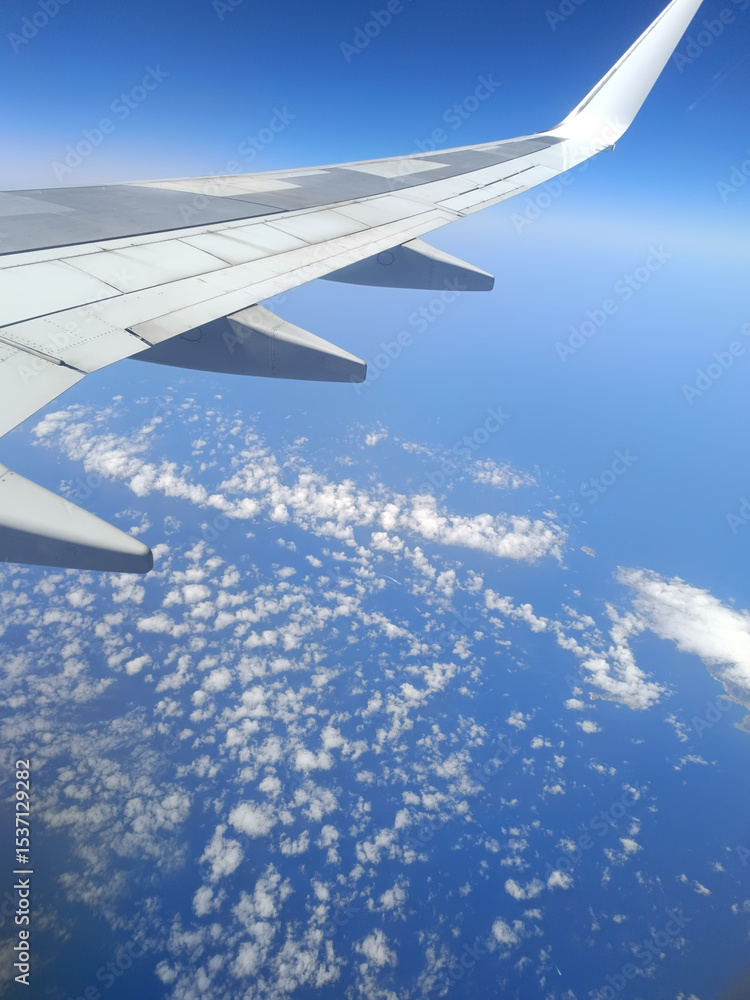 Fototapeta premium Aerial view from airplane window over the Mediterranean coast with wing in frame