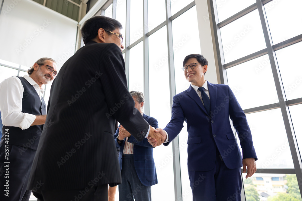 businessman shaking hands on business cooperation agreement. Successful Asian businessmen handshaking after good deal. successful negotiate, hand shake celebration partnership and business deal businessman shaking hands on business cooperation agreement. Successful Asian businessmen handshaking after good deal. successful negotiate, hand shake celebration partnership and business deal