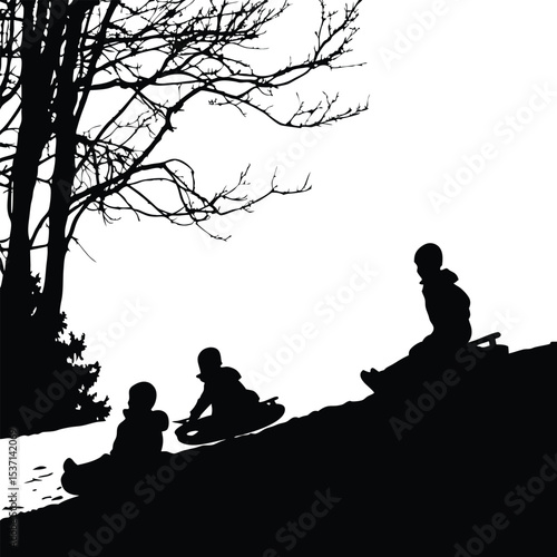Silhouette of Children Sledding Down a Hill in Winter Landscape