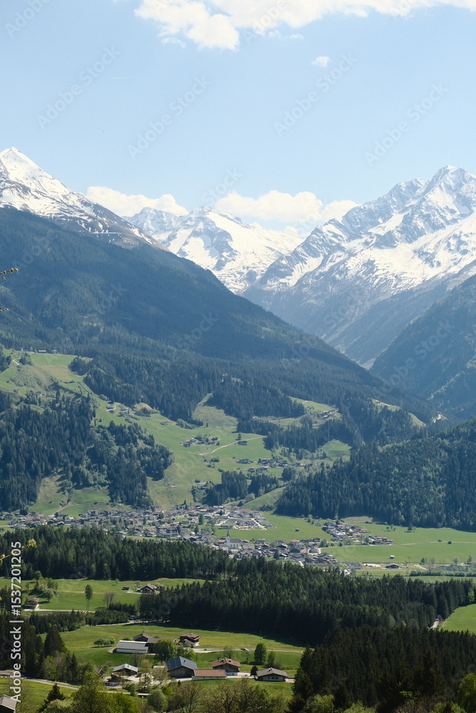 Fototapeta premium Scenic view of snow-capped mountains and lush green valleys in the Swiss Alps during a sunny day
