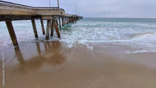 Pilares de muelle golpeado por las olas.