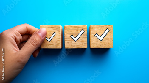 Wallpaper Mural Hand placing wooden block with check mark icon in a row in blue background Torontodigital.ca
