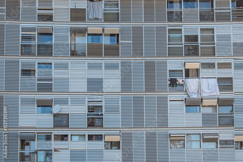 Geometric frontal view of the shutters and balconies of an urban building