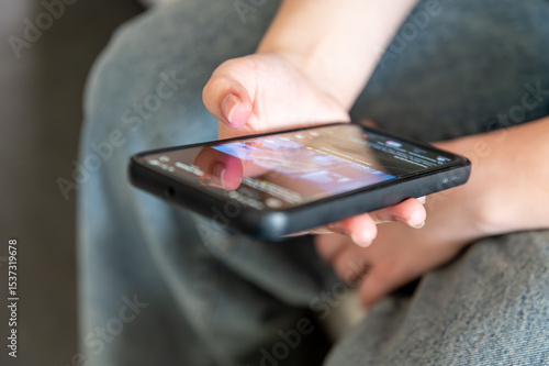 Εκτύπωση καμβά Young female hans with black smarphone watching screen