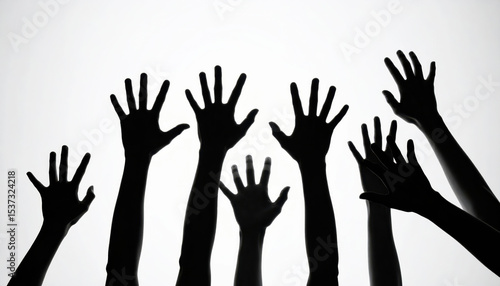 Silhouetted hands reaching upwards against white background create dramatic and eerie effect