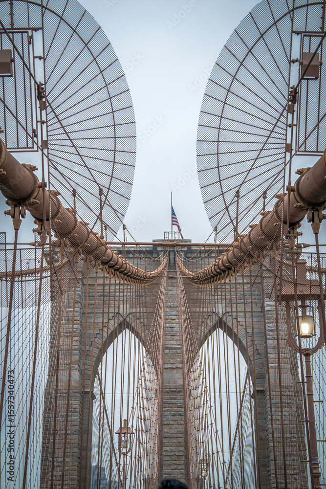 Fototapeta premium Brooklyn Bridge, the cable-stayed suspension bridge opened in 1883 in New York City spanning the East River between the boroughs of Manhattan and Brooklyn, in USA