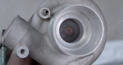 Turbocharger impeller spinning rapidly, filmed from a diagonal 45-degree angle, showing the internal motion of a high-speed engine component.