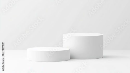 Two white cylindrical podiums on a plain background.