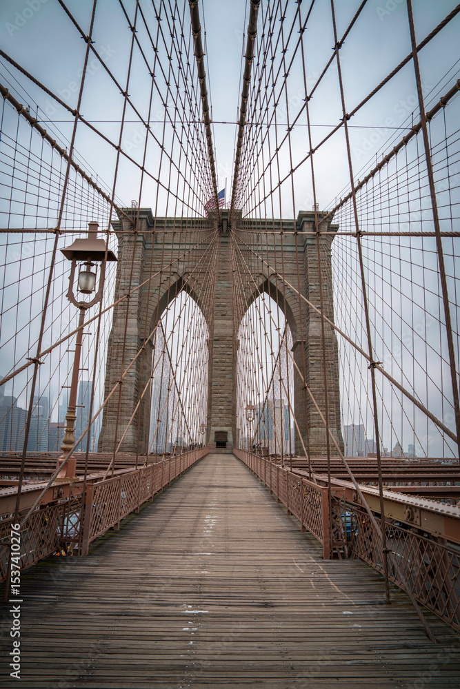 Fototapeta premium Brooklyn Bridge, the cable-stayed suspension bridge opened in 1883 in New York City spanning the East River between the boroughs of Manhattan and Brooklyn, in USA