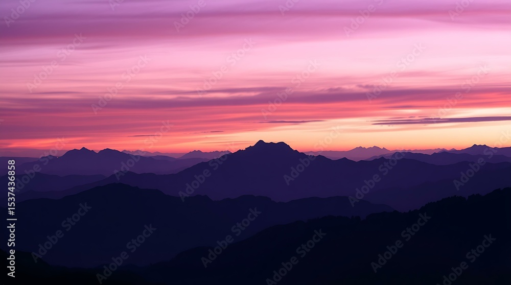 Fototapeta premium Silhouetted mountain ridge beneath purple twilight