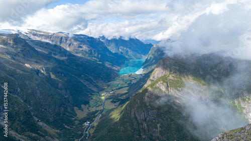 Bild auf Leinwand Glacier River Flowing from Briksdalsbreen Through Forested Valley