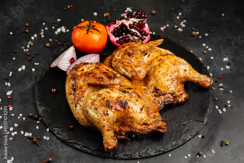 juicy golden grilled barbecue meat with spices on dark background