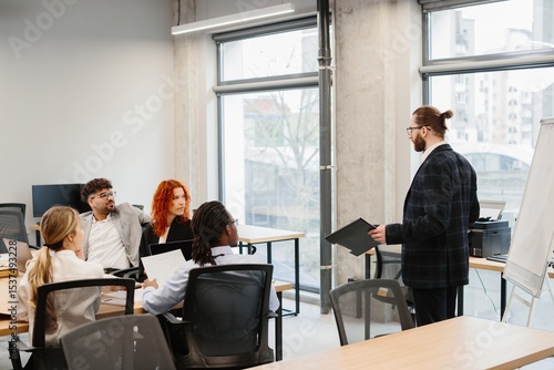 Businessman leading a presentation to his diverse team in the office