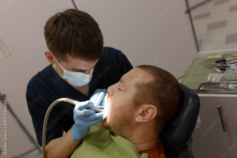 Fototapeta premium Dentist Examining Patient's Teeth