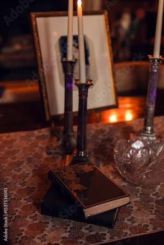 Valokuva Elegant candlelit setting with a vintage book and decorative items on a lace tab