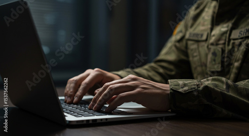 Soldier Typing on Laptop in Dark Room at Desk Military Professional Using Technology Security War