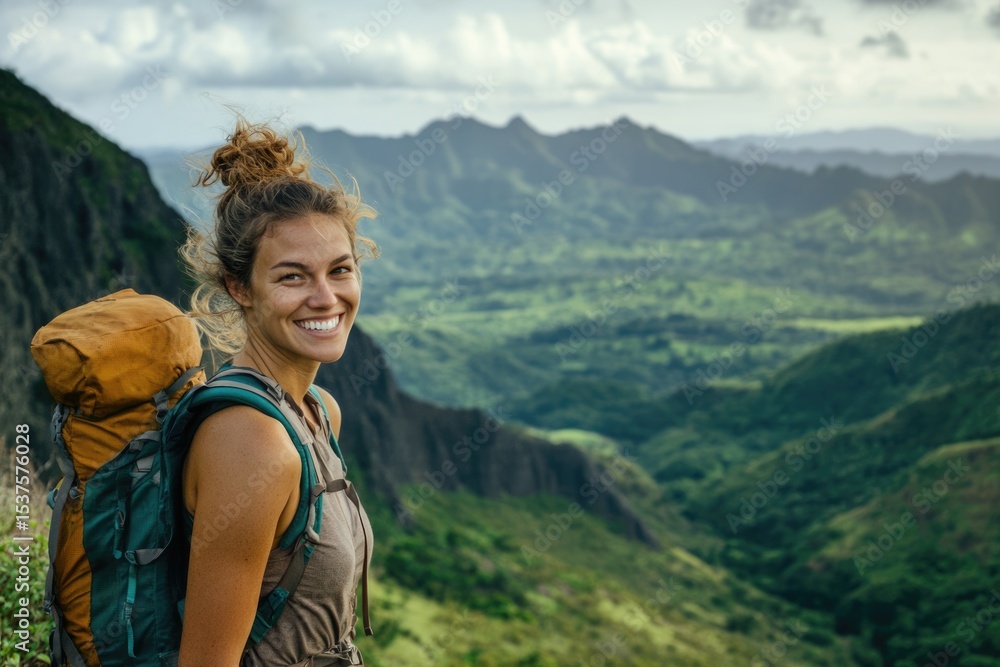 Naklejka premium A smiling woman with a backpack is enjoying the beautiful mountain scenery in the tropics.
