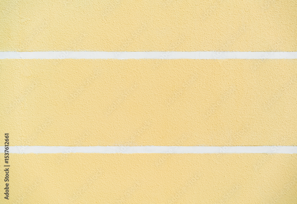 Fototapeta premium Painted yellow wall with rough concrete texture and two white horizontal lines