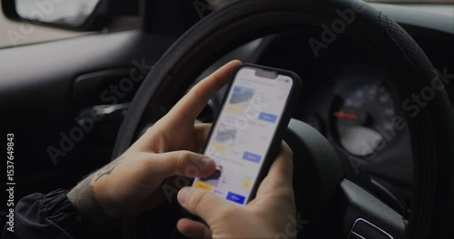 Man chooses to buy car on site. Looking at used vehicle to buy on smartphone app.  Screen is blurred. Close Up. 4K UHD. 