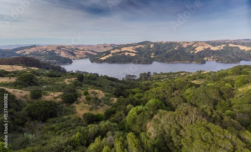 Aerial view of San Pablo Reservoir in Berkeley, California, USA. The reservoir provides drinking water and recreation, surrounded by rolling hills and lush greenery.