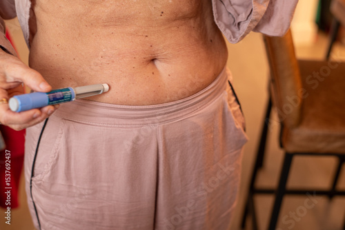 Woman Using Semaglutide Injection Pen for aesthetic purposes
