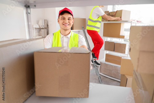 Male loader putting box on ...