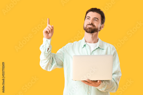 Handsome man with laptop po...