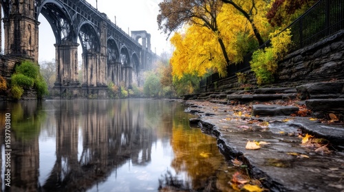 Autumnal bridge reflected in still water