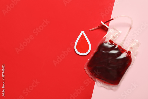 Konstfotografi Blood pack for transfusion with paper drop on color background