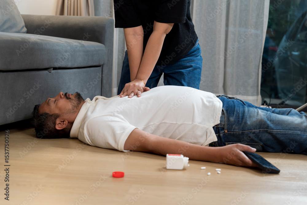Obraz premium Emergency CPR performed on unconscious man after possible overdose or collapse at home in critical situation