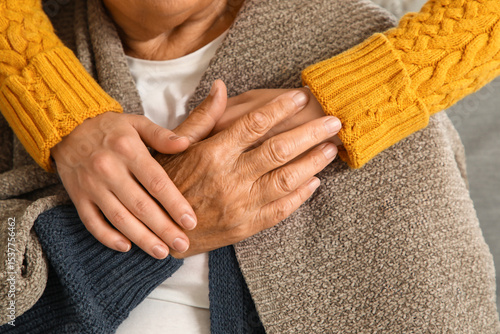Valokuva Young caregiver hugging senior woman with plaid at home, closeup