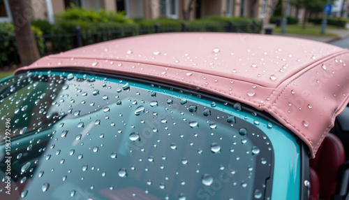 Pastel convertible car with wet roof covered in raindrops, showcasing vibrant design and refreshing atmosphere