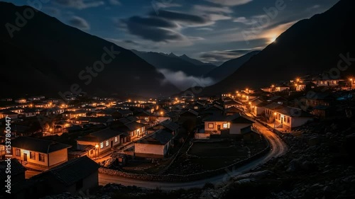 Scenic Nighttime Village View Amidst Mountains with Illuminated Houses and Pathway