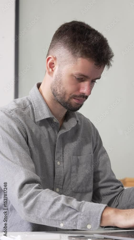 Young Caucasian male scientist works in laboratory, analyzing chemical samples with glassware and microscope. research tools, experiments, data interpretation, pharmaceutical development. Young Caucasian male scientist works in laboratory, analyzing chemical samples with glassware and microscope. research tools, experiments, data interpretation, pharmaceutical development.