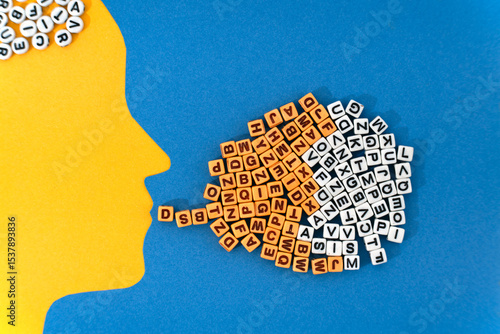 A paper-cut head with a cascade of letters flowing from its mouth symbolizing the transfer of ideas, emotional expression, and the complexity of human communication