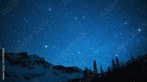 Bright stars over winter mountain peaks 