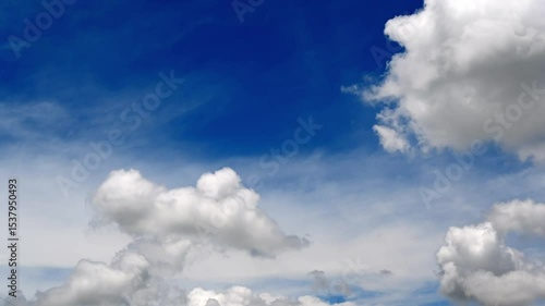 Bright Blue Sky with Fluffy White Clouds and Sunshine Atmosphere
