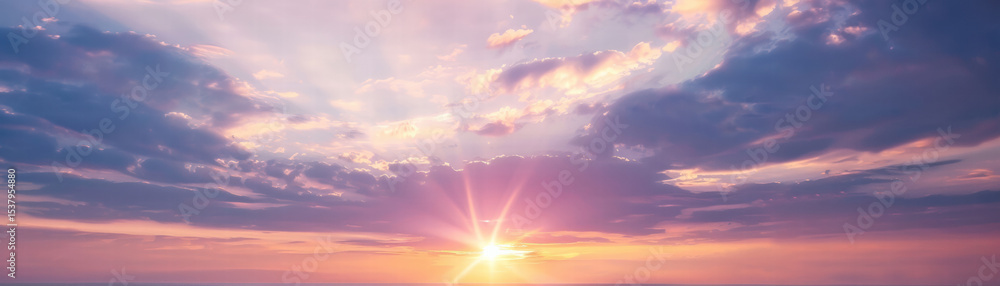 Fototapeta premium Purple sky sunset with sun rays shining through clouds creating peaceful atmosphere