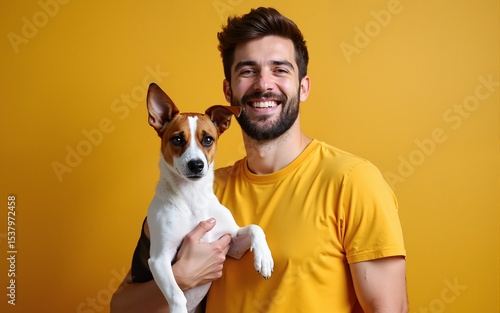 Animal, pet and people concept - Smiling man in casual mustard t-shirt with his jack russell terrier. High quality