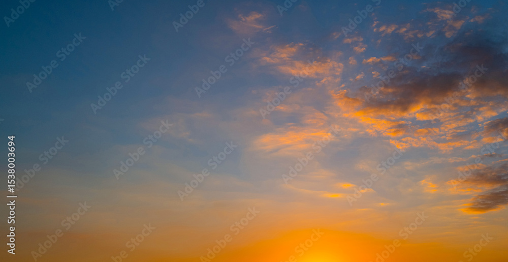 Fototapeta premium Sky on sunset. Beauty sunrise with sunlight background. Twilight, dramatic dawn, dusk, sunshine. Cloudy sunset. Sunset wallpaper. Sky sunset overlay. Peaceful horizon. Panorama of glow shiny sky.