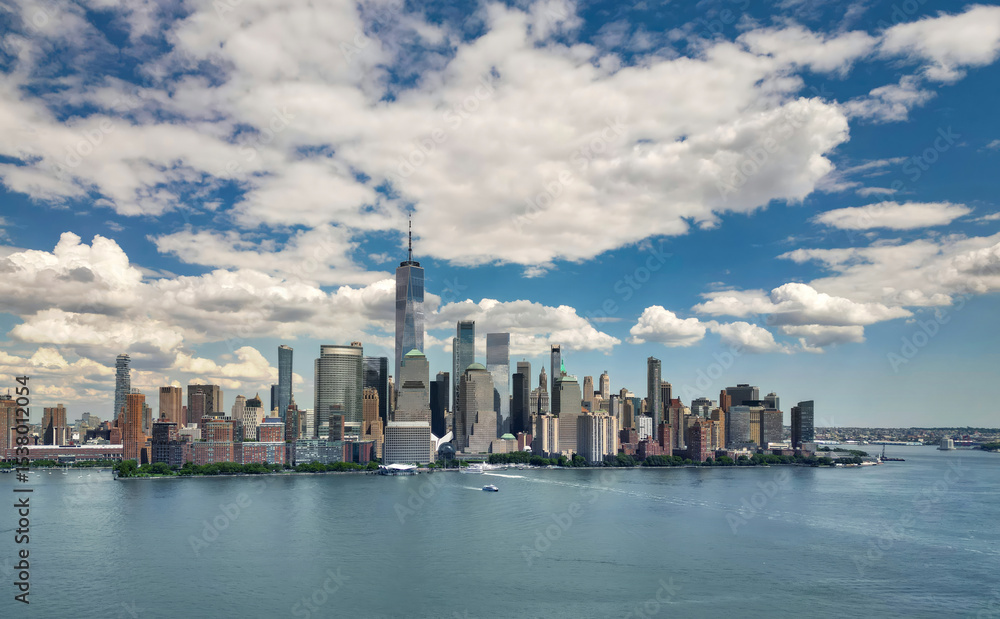 Obraz premium NYC aerial skyline, New York. Panorama view of New York city skyscrapers on blue sky. USA NYC. Lower NYC skyline on sunny day. New York cityscape. New York City with clouds from drone.