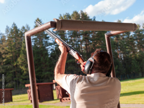 man practicing on clay target shooting