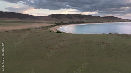 Aerial footage of Kelvedon Beach, Tasmania at sunrise. Captured after a night storm, the video shows moody skies, soft light, and serene coastal beauty in 4K.