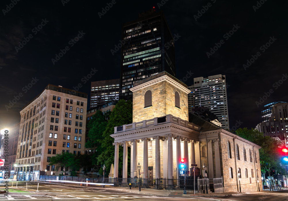 Fototapeta premium King's Chapel glowing at night amid downtown Boston skyscrapers, United States